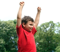 autism-resources-happy-young-boy-throwing-arms-up-in-excitement