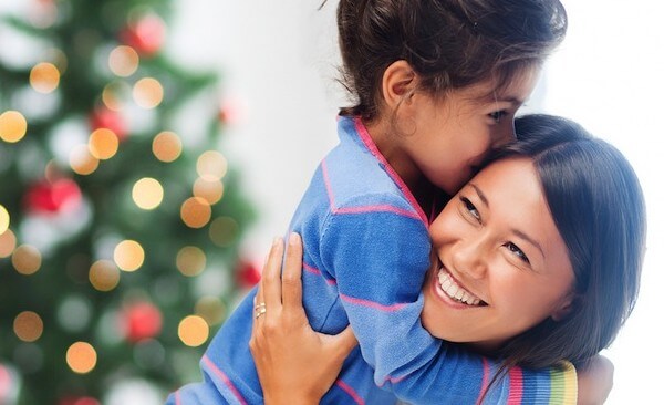 autism-resouces-mom-giving-her-daughter-a-hug-with-christmas-tree-in-the-background