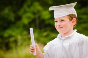 autism-resources-boy-with-cap-and-gown-holding-certificate
