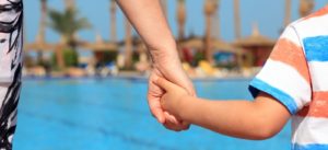 autism-resources-mother-holding-sons-hand-at-pool