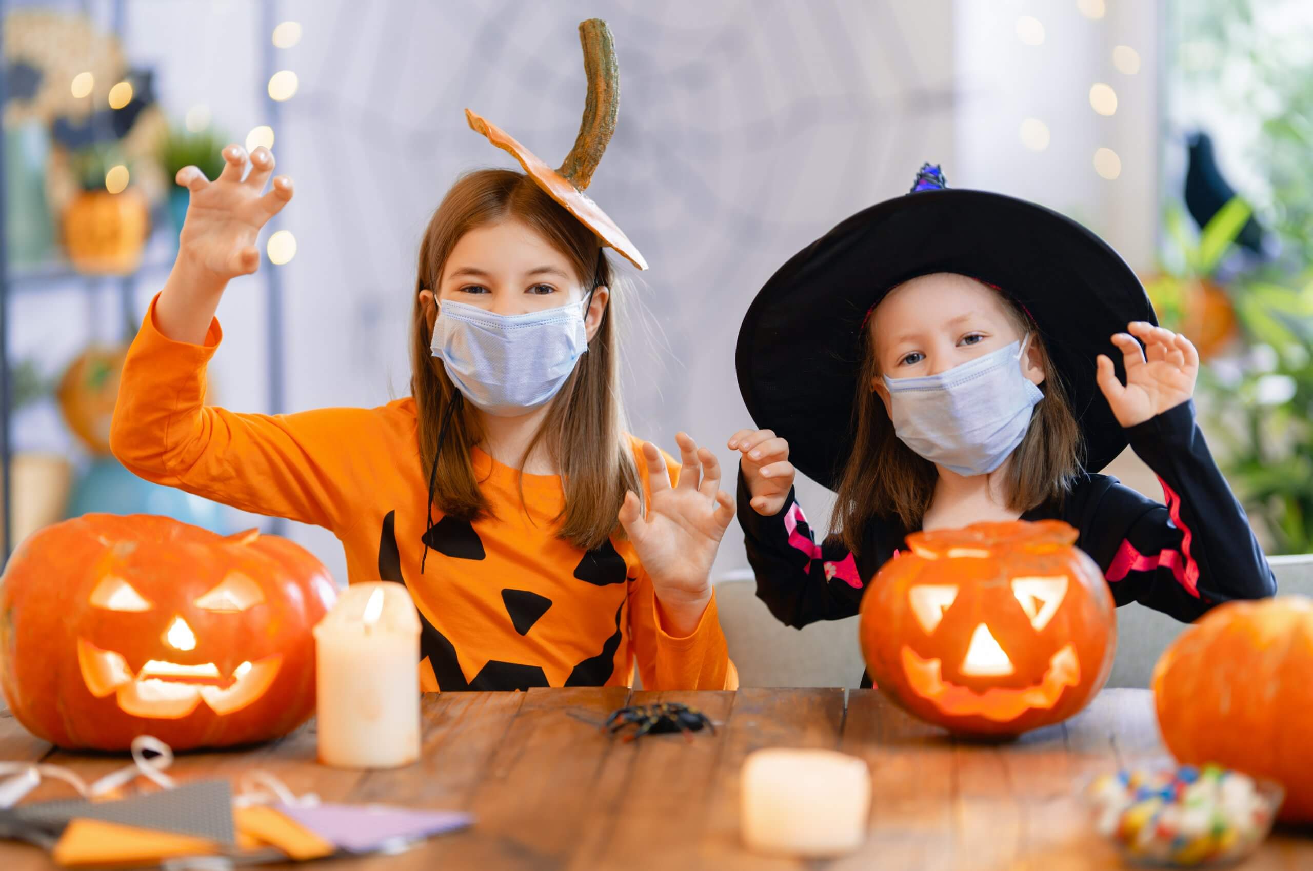 Cute little children girls in carnival costumes wearing face mas