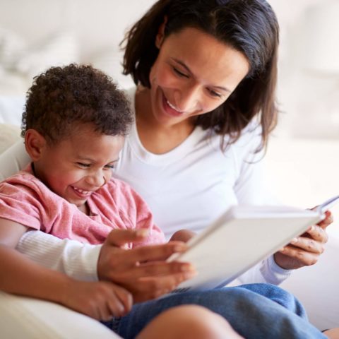 Close up of mixed race young adult mother sitting in an armchair