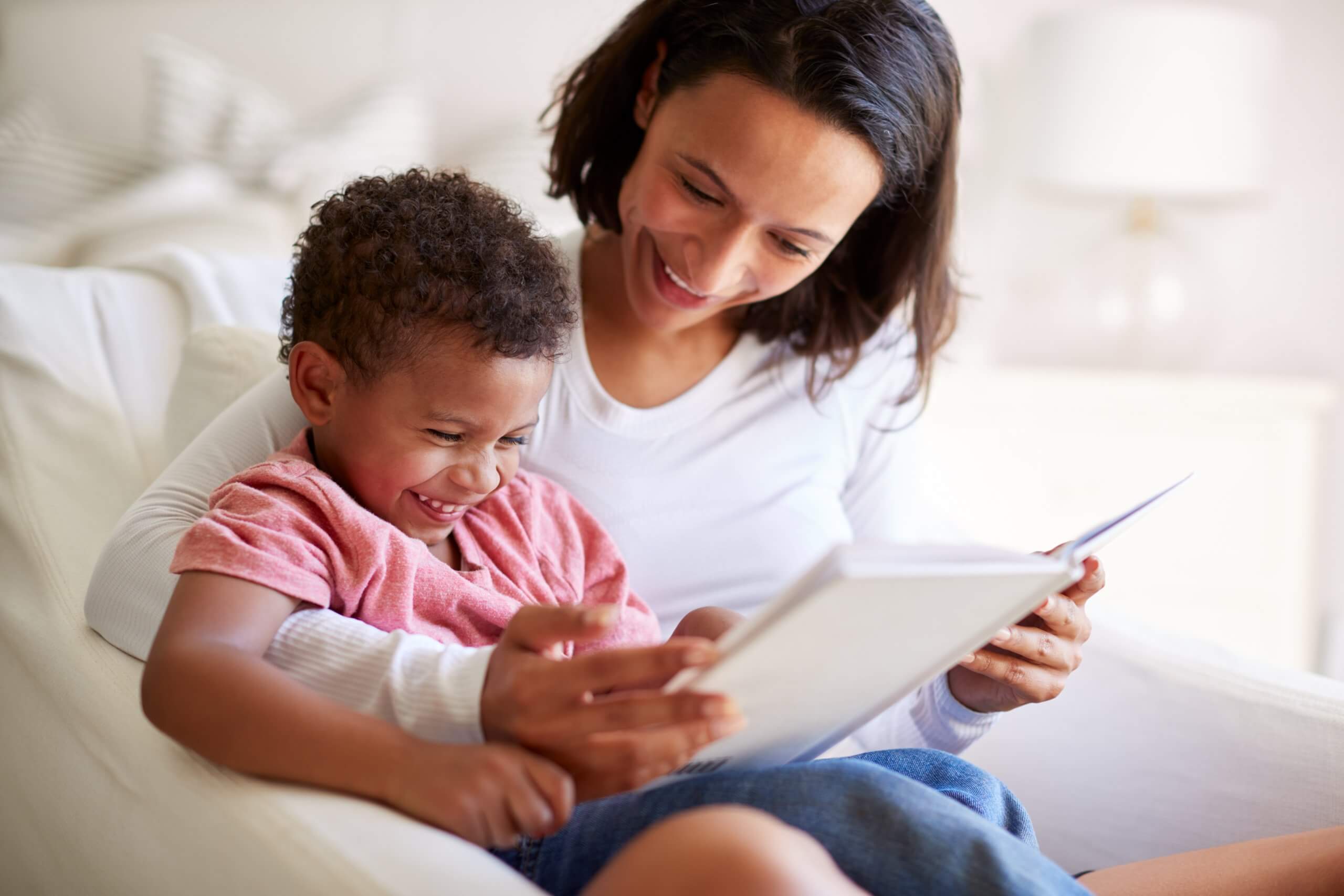 Close up of mixed race young adult mother sitting in an armchair