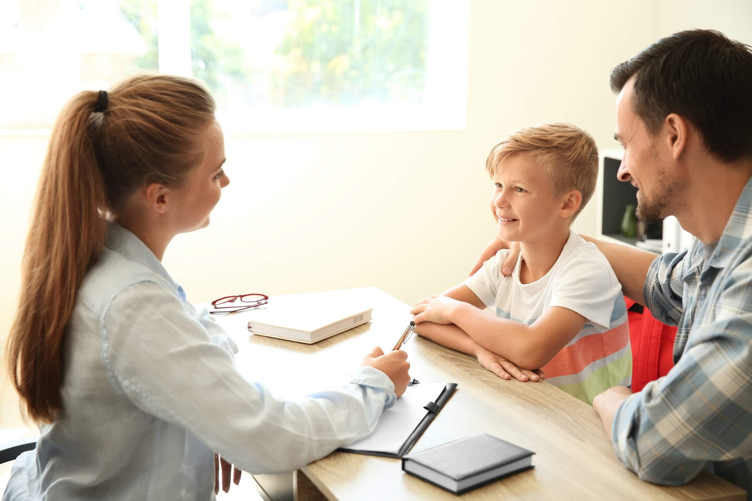 Young,Man,And,His,Son,Meeting,With,Headmistress,At,School